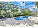 Inviting screened-in pool area with a refreshing pool and lounge chairs for relaxing at 5247 Wildwood Way, Davenport, FL 33837