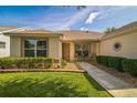 Inviting front entrance with stone pathway, small seating area, and manicured landscaping for curb appeal at 9345 Se 171St Le Flore Ln, The Villages, FL 32162