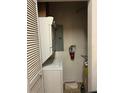 Stacked washer and dryer with hot water heater in condo unit at 12849 Madison Pointe Cir # 204, Orlando, FL 32821