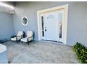 Cozy front porch sitting area with seating and decorative nautical accents at 1895 Snapper Dr, Kissimmee, FL 34759