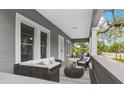 Inviting front porch with stylish seating, creating a perfect spot to relax and enjoy the neighborhood views at 630 Pear St, Lakeland, FL 33815