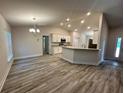 Spacious living area flows into a kitchen with stone countertops and stainless steel appliances at 1259 Groveland Ln, Lakeland, FL 33811