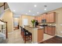 Well-equipped kitchen with granite counters, breakfast bar, and stainless steel appliances, ideal for cooking at 2417 Passamonte Dr # 1E, Winter Park, FL 32792