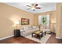 Relaxing living room with a plush sofa, decorative pillows, and a view of the well-lit window at 2417 Passamonte Dr # 1E, Winter Park, FL 32792