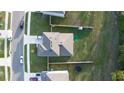 Aerial view of a home showcasing a well-manicured backyard, fenced perimeter, and lush greenery at 5189 Greenheart Ave, Mount Dora, FL 32757