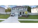 Charming two-story home with a well-maintained lawn, attached garage, and gray paint at 5189 Greenheart Ave, Mount Dora, FL 32757