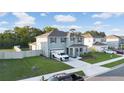 Two-story home with a well-manicured lawn, attached garage, and a long driveway for ample parking at 5189 Greenheart Ave, Mount Dora, FL 32757