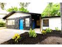 Unique home featuring rock accents, a bright blue front door, and a freshly landscaped yard at 808 S Clara Ave, Deland, FL 32720