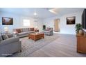 Bright, neutrally-toned living room is virtually staged with comfortable seating and modern decor at 808 S Clara Ave, Deland, FL 32720
