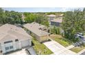 Aerial view of a well-maintained single-story home with an attached garage, driveway, and a neatly kept lawn at 1309 Timberbend Cir, Orlando, FL 32824
