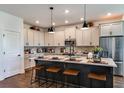 Bright kitchen with large island, pendant lighting, stainless steel appliances, and modern cabinetry at 17020 Cercis Loop, Clermont, FL 34711
