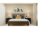 Beautifully staged bedroom with minimalist decor, lamps, and complementary nightstands at 2180 Albatross Nest Dr, Bartow, FL 33830