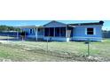 This cozy home features a screened lanai and a beautiful yard, fully fenced at 4300 Meadow Ridge Ave, Mulberry, FL 33860