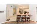 Open kitchen view with breakfast bar, stainless steel appliances and tile flooring at 24 Lake Vista Way, Ormond Beach, FL 32174