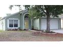 Charming one-story home with a well-maintained lawn and attached two-car garage at 1048 Winding Water Way, Clermont, FL 34714
