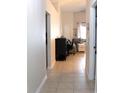 Bright hallway with tile flooring, connecting to the living room and other areas of the home at 1048 Winding Water Way, Clermont, FL 34714