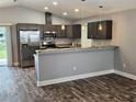 Modern kitchen with stainless steel appliances, stylish countertops, and dark wooden flooring at 1121 W 9Th St, Lakeland, FL 33805