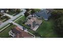 Aerial view of a home with solar panels and a beautifully landscaped backyard perfect for entertaining at 16325 Magnolia Bluff Dr, Montverde, FL 34756