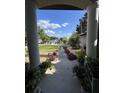 View from the front entrance showing a neatly landscaped walkway leading to a well-maintained street at 16325 Magnolia Bluff Dr, Montverde, FL 34756