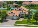 Beautiful home with a three-car garage, landscaped yard, and a brick driveway at 3939 Sunset Lake Dr, Lakeland, FL 33810