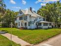 Classic two-story home showcasing a well-manicured lawn and mature trees at 485 E Stanford St, Bartow, FL 33830