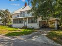 A charming two-story home with a metal roof, covered porch, and convenient carport at 485 E Stanford St, Bartow, FL 33830