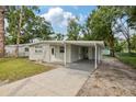 Well-maintained single-story home featuring a convenient covered carport and a tidy front yard at 728 Trenton Rd, Lakeland, FL 33815