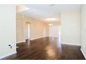 Spacious living room with hardwood floors, neutral paint and access to the backyard at 4526 Ficus Tree Rd, Kissimmee, FL 34758