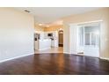 Open-concept floor plan with hardwood floors and white trim throughout the living spaces at 4526 Ficus Tree Rd, Kissimmee, FL 34758