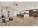 Spacious open floor plan with a large kitchen island and modern pendant lighting at 6376 Sw 117Th Street Rd, Ocala, FL 34476