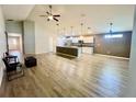 Open-concept living space features hardwood floors, a ceiling fan and an open design at 6376 Sw 117Th Street Rd, Ocala, FL 34476