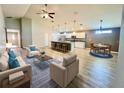 Open-concept living room with eat-in kitchen, island, and modern decor with lots of natural light at 6376 Sw 117Th Street Rd, Ocala, FL 34476