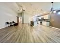 Open-concept living space features hardwood floors, a ceiling fan and an open design at 6376 Sw 117Th Street Rd, Ocala, FL 34476