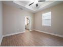 Comfortable bedroom with hardwood floors, a ceiling fan, and large window at 7890 Somersworth Dr, Kissimmee, FL 34747