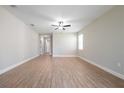 Spacious living room with durable hardwood flooring and a modern ceiling fan at 7890 Somersworth Dr, Kissimmee, FL 34747