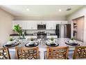 Modern kitchen featuring stainless steel appliances, white cabinetry and a large island with barstool seating at 1609 Sage Ave, Haines City, FL 33844