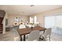 Open-concept living and dining area featuring modern furnishings, neutral decor, and bright natural light at 1617 Sage Ave, Haines City, FL 33844