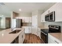 Modern kitchen with stainless steel appliances, quartz countertops, and a central island at 4035 Gardenia Ave, Lake Hamilton, FL 33851