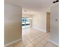 Open dining area featuring neutral walls, tile flooring, and a view of the outdoor patio at 6255 Christina Ct, Orlando, FL 32810