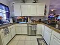 Efficient kitchen with stainless steel appliances and white cabinets at 205 Golf Aire Blvd, Haines City, FL 33844