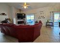 Spacious living room featuring a fireplace, tile floors, and sliding glass doors to the lanai at 205 Golf Aire Blvd, Haines City, FL 33844