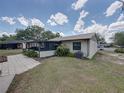 Home showcasing a screened patio, a well-kept lawn, and mature landscaping at 2271 Crystal Grove Ln, Lakeland, FL 33801