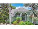 Beautiful home exterior featuring a well-manicured lawn, mature palm trees, and welcoming entryway at 2806 Spinning Silk Ct, Kissimmee, FL 34747