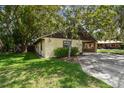 View of the side of the home and its lovely green grass at 519 Market W Sq, Lakeland, FL 33813