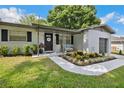 Inviting front porch with decorative plants and bench seating creates a cozy entrance at 811 Patricia Pl, Lakeland, FL 33809