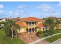 Beautiful Mediterranean-style home with a tile roof, manicured lawn, and three-car garage at 1140 Terralago Way, Kissimmee, FL 34746