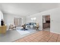 Bright living room with neutral tones, and views of the bonus room and kitchen at 1212 Blake Ave, Auburndale, FL 33823