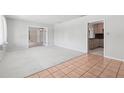 Open living space featuring plush carpeting and tile flooring, bonus room and access to kitchen at 1212 Blake Ave, Auburndale, FL 33823