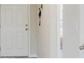 View of a white front door, leading into an interior space with light-colored walls at 1424 Axel Cir, Winter Haven, FL 33880
