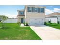Well-maintained front yard with lush green grass leading to a charming two-story home at 1508 Majestic Ln, Winter Haven, FL 33880